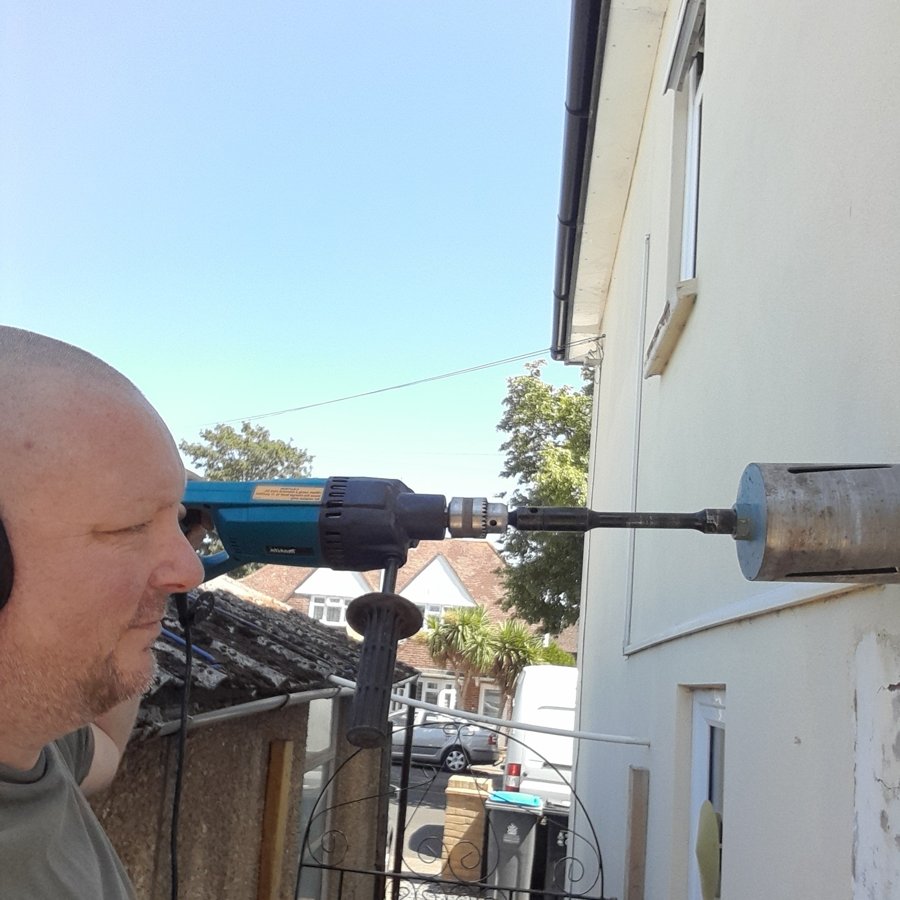 Andy from A.M. Lander Gas, Heating & Plumbing using a core drill on site